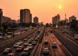 a city with tall buildings and congested streets, highways