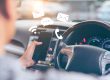 Man using smartphone while driving the car