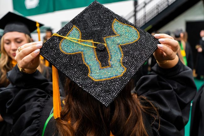 20260507-UCM-Commencement-Masters-58 graduating student displaying her decorated graduation cap with the USF bulls U logo